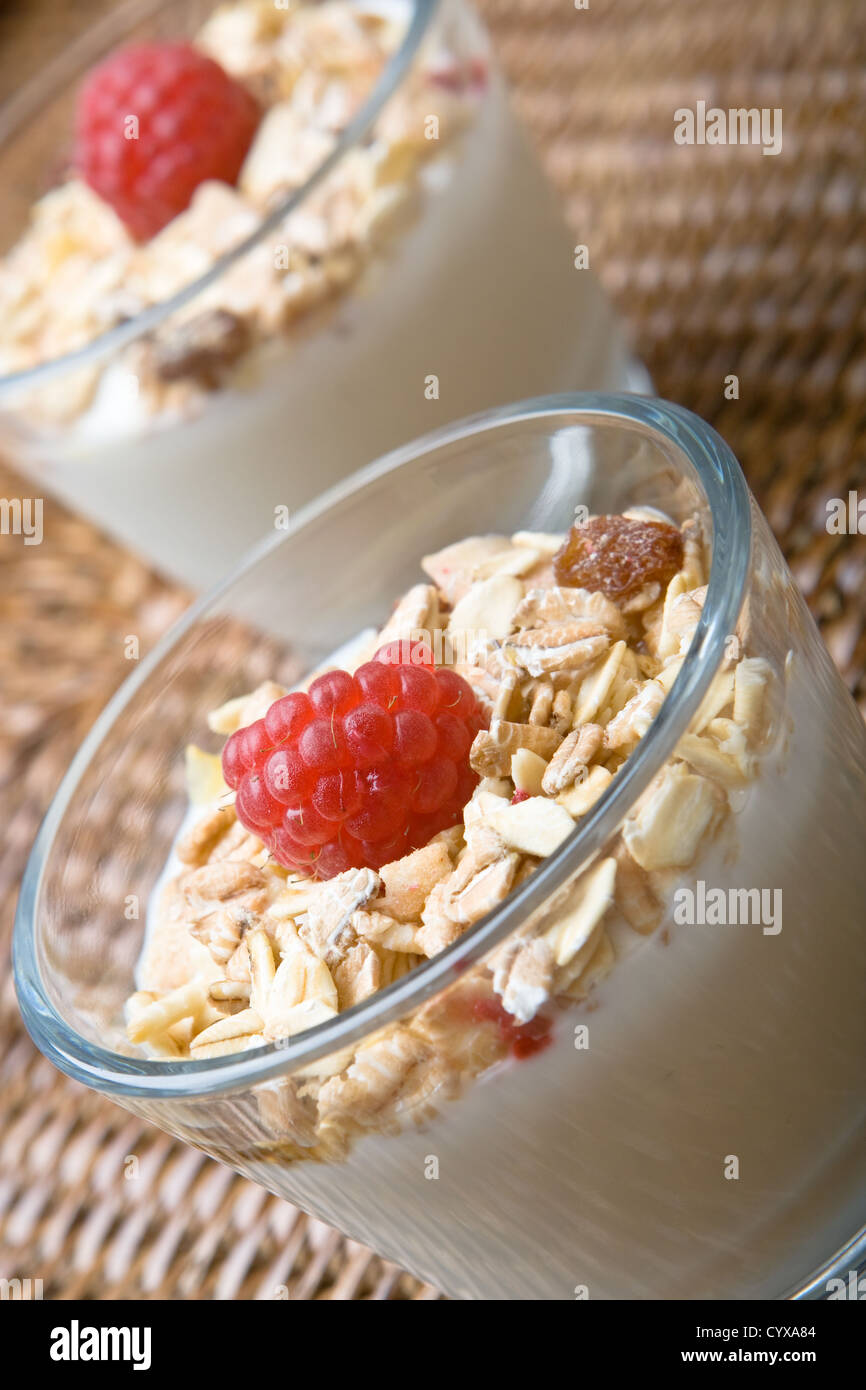 Fresh yogurt and muesli with a raspberry Stock Photo Alamy