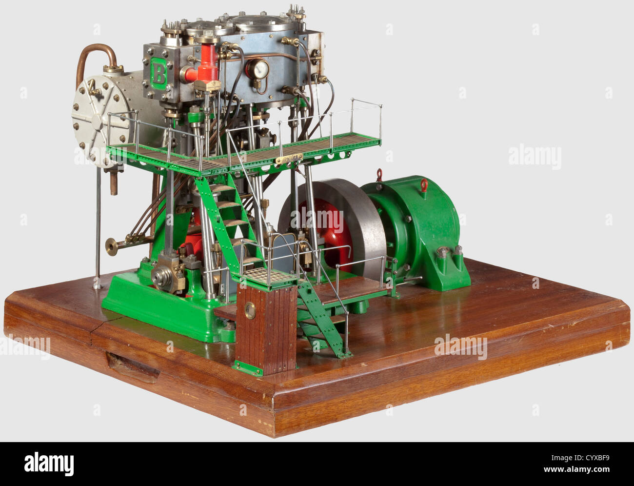 A fine and rare model twin cylinder compound vertical condensing generating set,Built by J. Nichols Gloucester 1977 from Bateman castings with blued steel clad cylinders(cylinder head lubricators missing),valve chest pressure gauge,draincocks and fine pipe work,regulator valve,counterbalanced crankshaft running in four main bearings,disc flywheel and direct coupled round frame dynamo. Other details include LP crosshead driven air pump,tubed condenser,lagged steam pipes,laddered walk ways and wooden base,finished in red,green and polished bright work,Additional-Rights-Clearences-Not Available Stock Photo