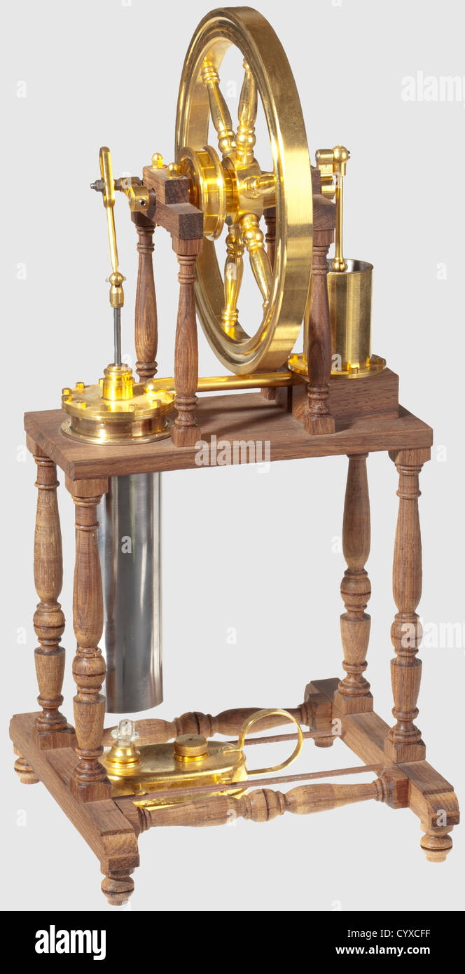 A delicate plated model stirling cycle engine and spirit burner, Raised on a wooden frame with centrally mounted crankshaft, spoked flywheel and rope pulley, power and displacer cylinders supported on four turned wood columns, unpainted. 34 x 15 cm. œ 700 ? 1000, historic, historical, 20th century, steam engine, steam engines, machine, machines, technology, engineering, object, objects, stills, drive, propulsion, motor, power unit, drives, clipping, cut out, cut-out, cut-outs, Additional-Rights-Clearences-Not Available Stock Photo