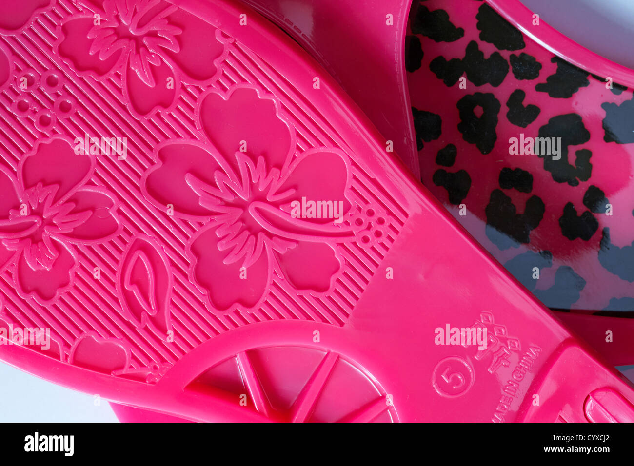 tread on bottom of pair of size 5 pink sandals made in China Stock Photo
