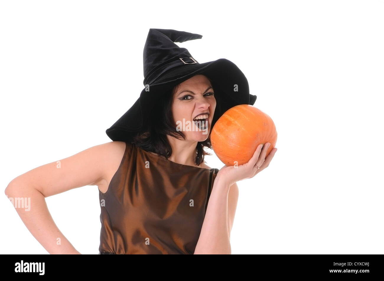 Young witch with a pumpkin isolated on white background Stock Photo