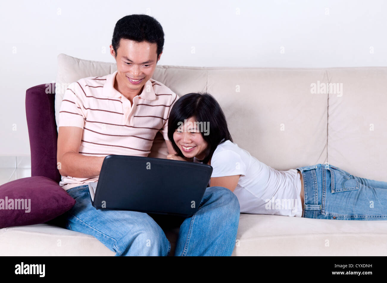 Asian young couple sharing informations from internet. Stock Photo