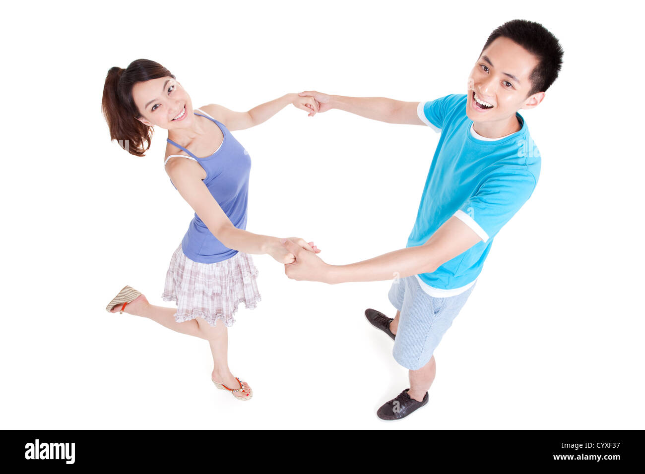 Happy young couple holding hands Stock Photo - Alamy