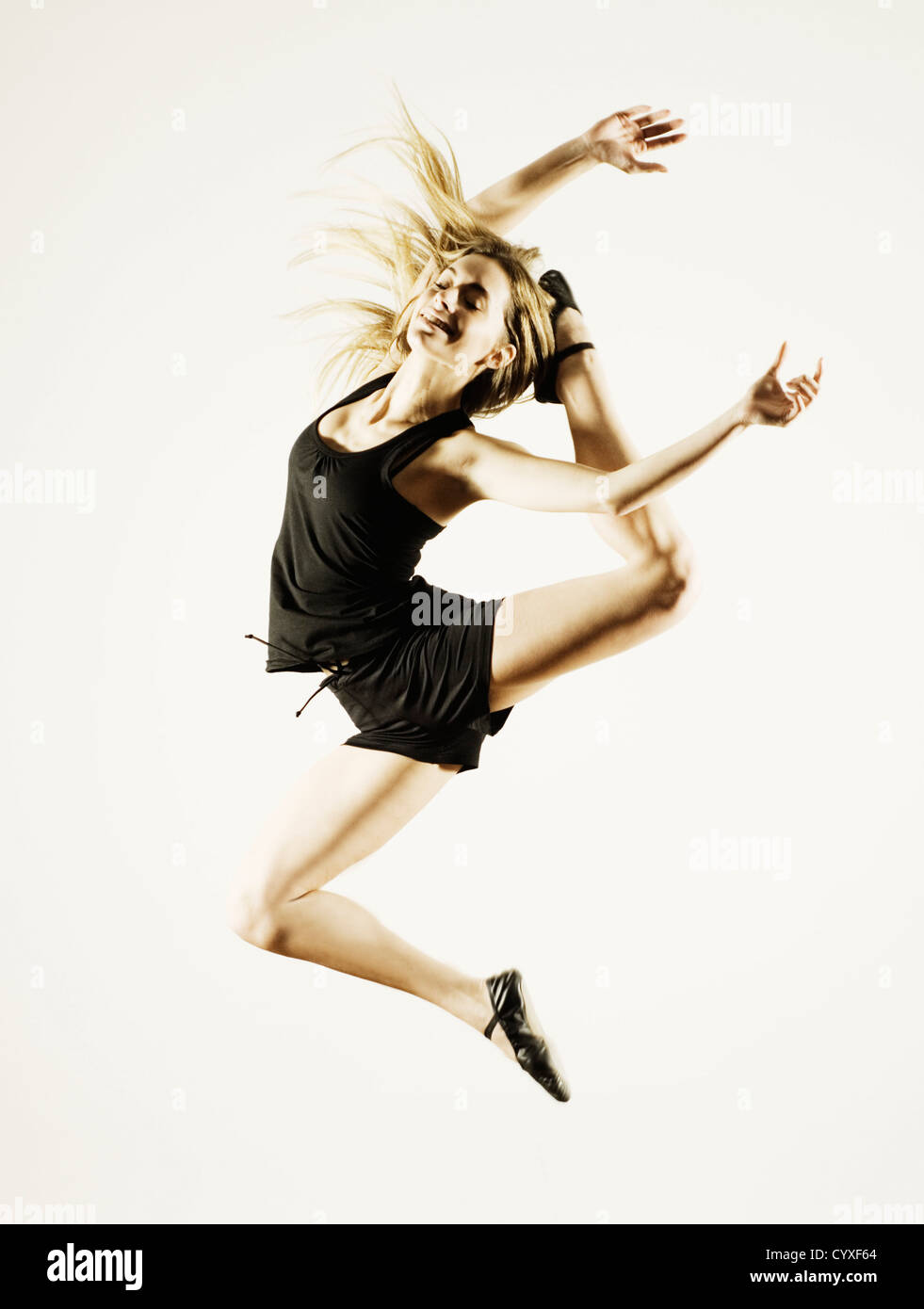 Young woman in sportswear jumping against white background Stock Photo ...