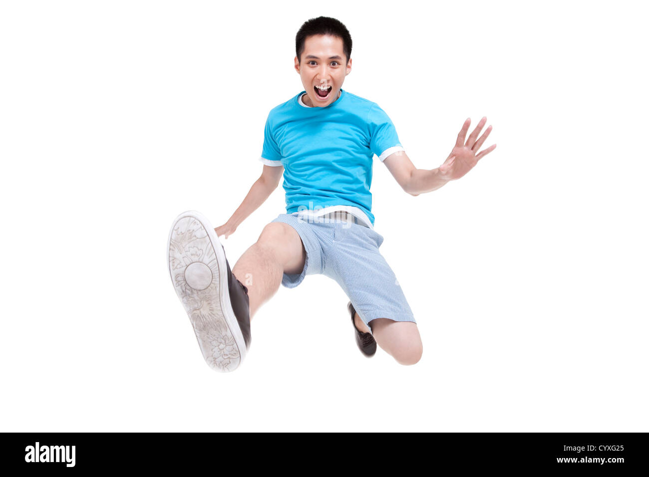Excited young man jumping in mid air Stock Photo - Alamy