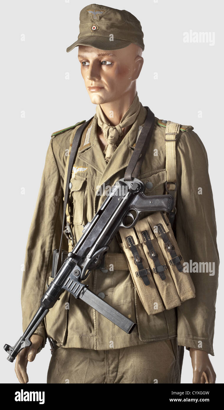 An Afrika Corps uniform ensemble,of an Unteroffizier in North Africa Reed  green field cap M 40 for the Afrika Korps,complete with insignia with  sand-coloured background cloth.Maker information inside "Hans Brandl  Mützenfabrik Magdeburg"