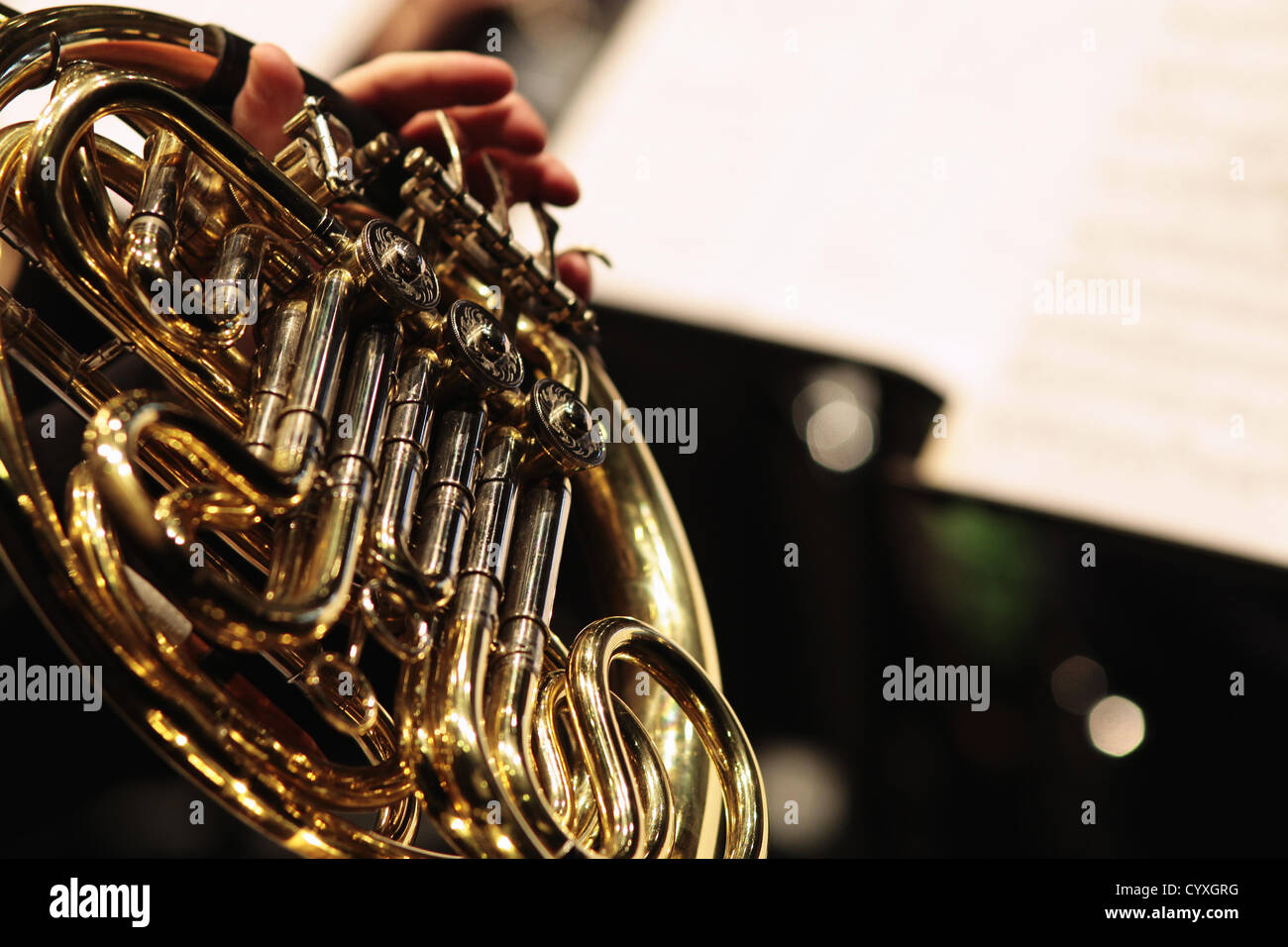 Detail of hand playing notes on a french horn hi-res stock photography ...