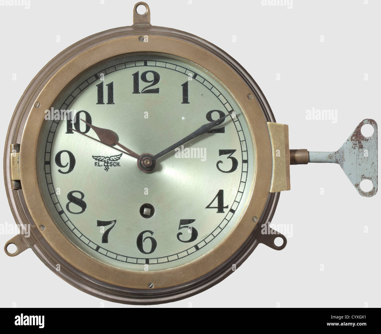 A Luftwaffe wall clock,from a fire control ship of the Flak artillery Brass case,black stamped numerals,blued hands,glass cover. The face of the clock has the Luftwaffe eagle and abbreviation 'F.L.Sch.'(Feuerleitschiff,tr. fire control ship). Made by Kieninger & Obergfell. Diameter 20 cm. Complete with key. Still functional. Very rare. Cf. Knirim,Uhren(Clocks),p. 313,historic,historical,1930s,1930s,20th century,Air Force,branch of service,branches of service,armed service,armed services,military,militaria,air forces,object,objects,still,Additional-Rights-Clearences-Not Available Stock Photo