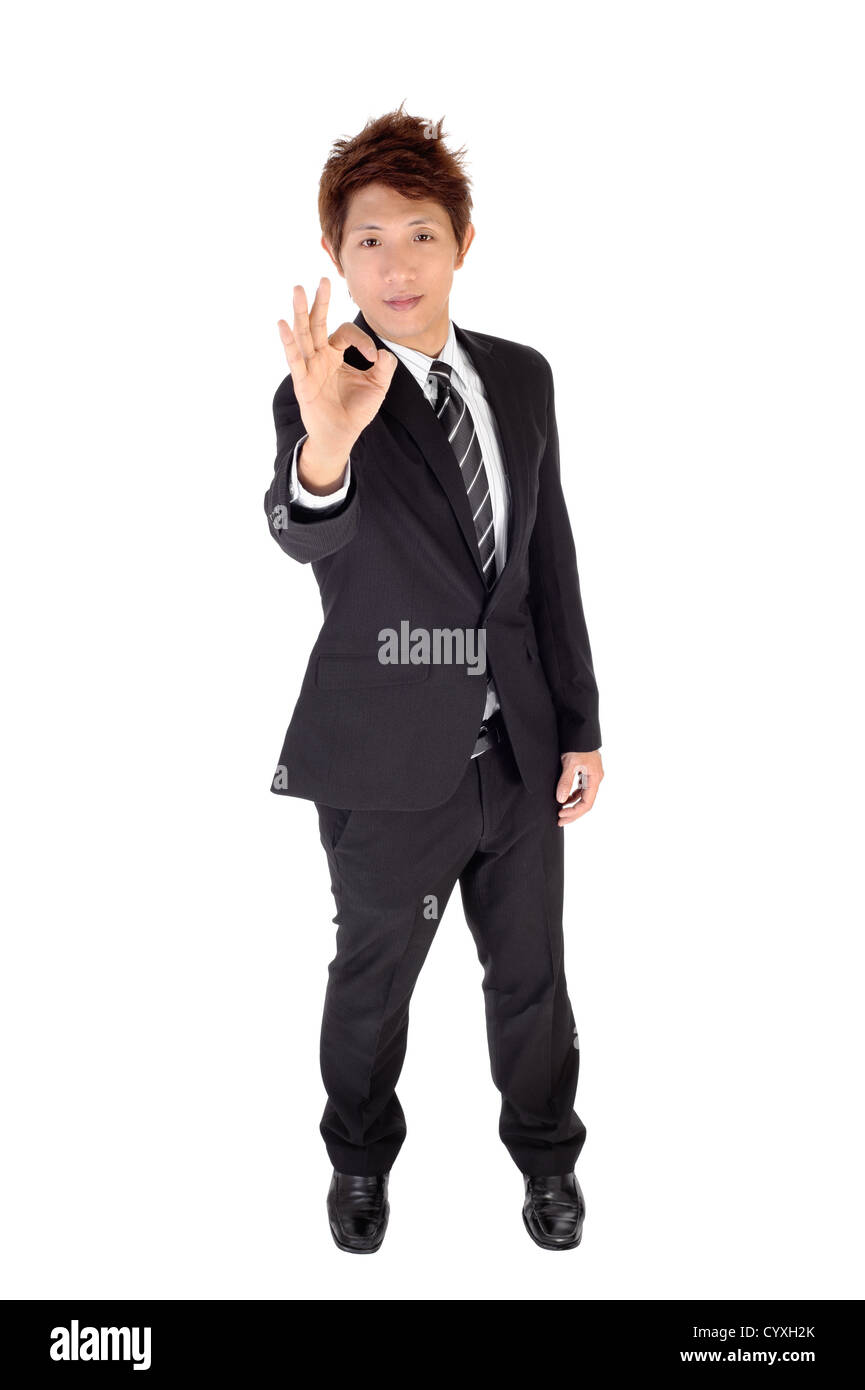 Young executive show approve gesture, full length portrait isolated on white. Stock Photo