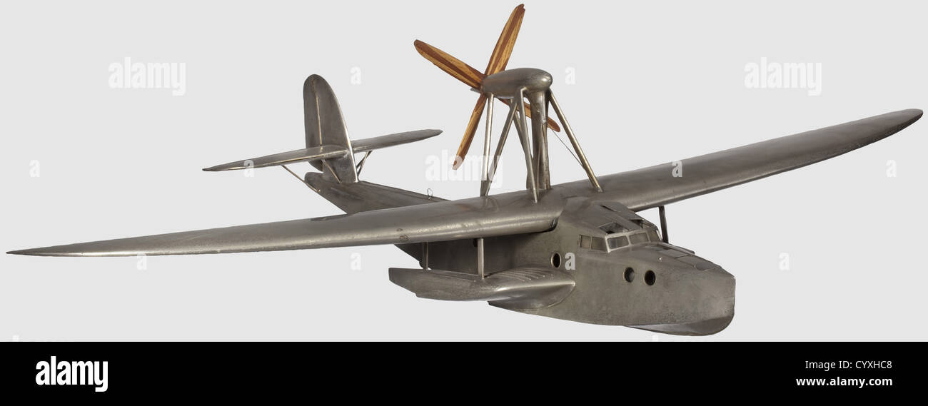 A Dornier Do 14,a rare model of transocean experimental flying boat Nickel-plated brass static 1/20th scale model of this aircraft.The 90 cm long fuselage with nose mooring hatch with hinged cover,pennant socket,celluloid glazed cabin windows,sliding cover to crew entrance hatch,the two pilot's compartment or cabin with turn seats,control columns and rudder pedals,the engineers hinged hatch lifting to reveal a step ladder to engine-room and cabin with sleeping-bunk,the two back-to-back dummy 690 HP BMW VI engines with transfer gearbox for v,Additional-Rights-Clearences-Not Available Stock Photo