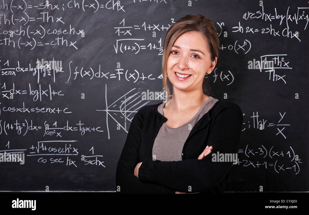 smiling teacher and slate blackboard background Stock Photo - Alamy