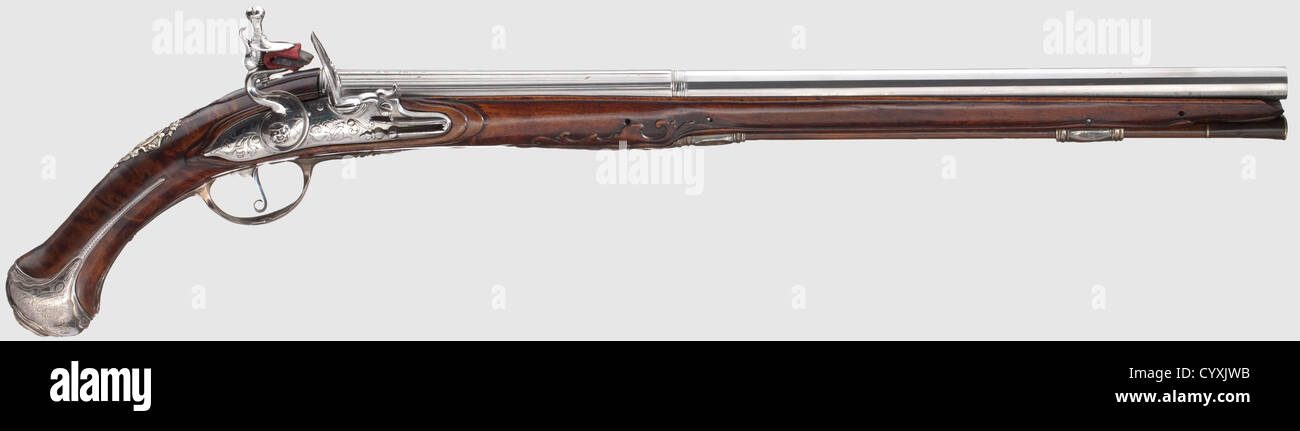 A long Italian flintlock pistol,Italy,circa 1730. Fluted barrel,facetted after baluster with 13.5 mm calibre,on upper side marked 'Gio:Batt:Francino'. Flintlock with fine tendril engraving. Beautifully grained stock with silver furniture. Wooden ramrod with horn tip. Expertly reworked and restored weapon,crack in trigger and side plate area. Length 59 cm,historic,historical,18th century,civil handgun,civil handguns,handheld,gun,guns,firearm,fire arm,firearms,fire arms,weapons,arms,weapon,arm,object,objects,stills,clipping,clippings,cu,Additional-Rights-Clearences-Not Available Stock Photo