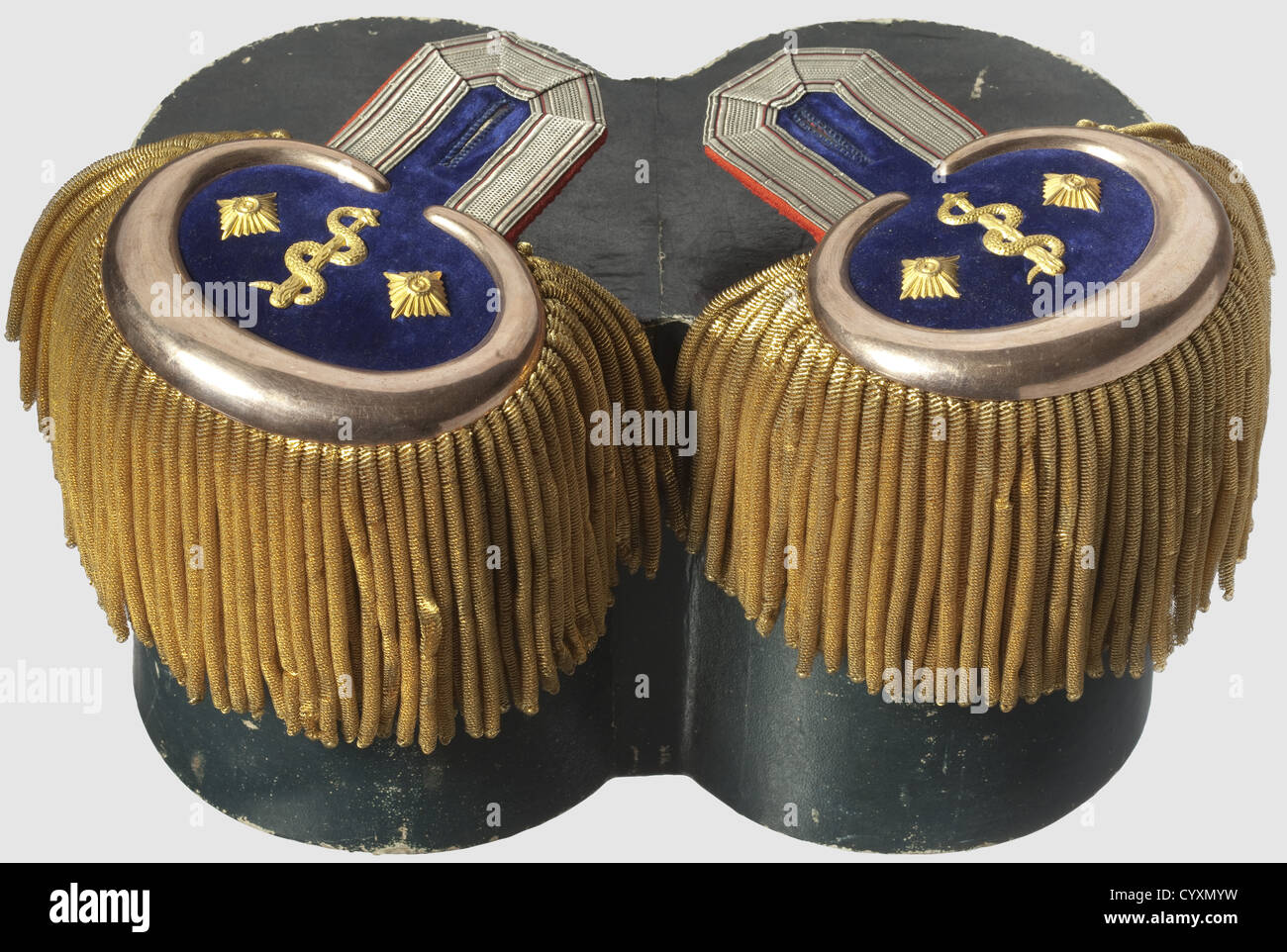 A pair of epaulettes for a full dress tunic,of a Wurttemberg general surgeon in the rank of a colonel Bright red velvet,silver borders with black-red interlaces,gold fringes,copper crescent moons,each with two rank stars and a gold rod of Asclepius on dark blue velvet. In cardboard box(slightly damaged),historic,historical,19th century,Wuerttemberg,Wurttemberg,Württemberg,Southern Germany,the South of Germany,south german,object,objects,stills,clipping,clippings,cut out,cut-out,cut-outs,utensil,piece of equipment,utensils,item,items,Additional-Rights-Clearences-Not Available Stock Photo
