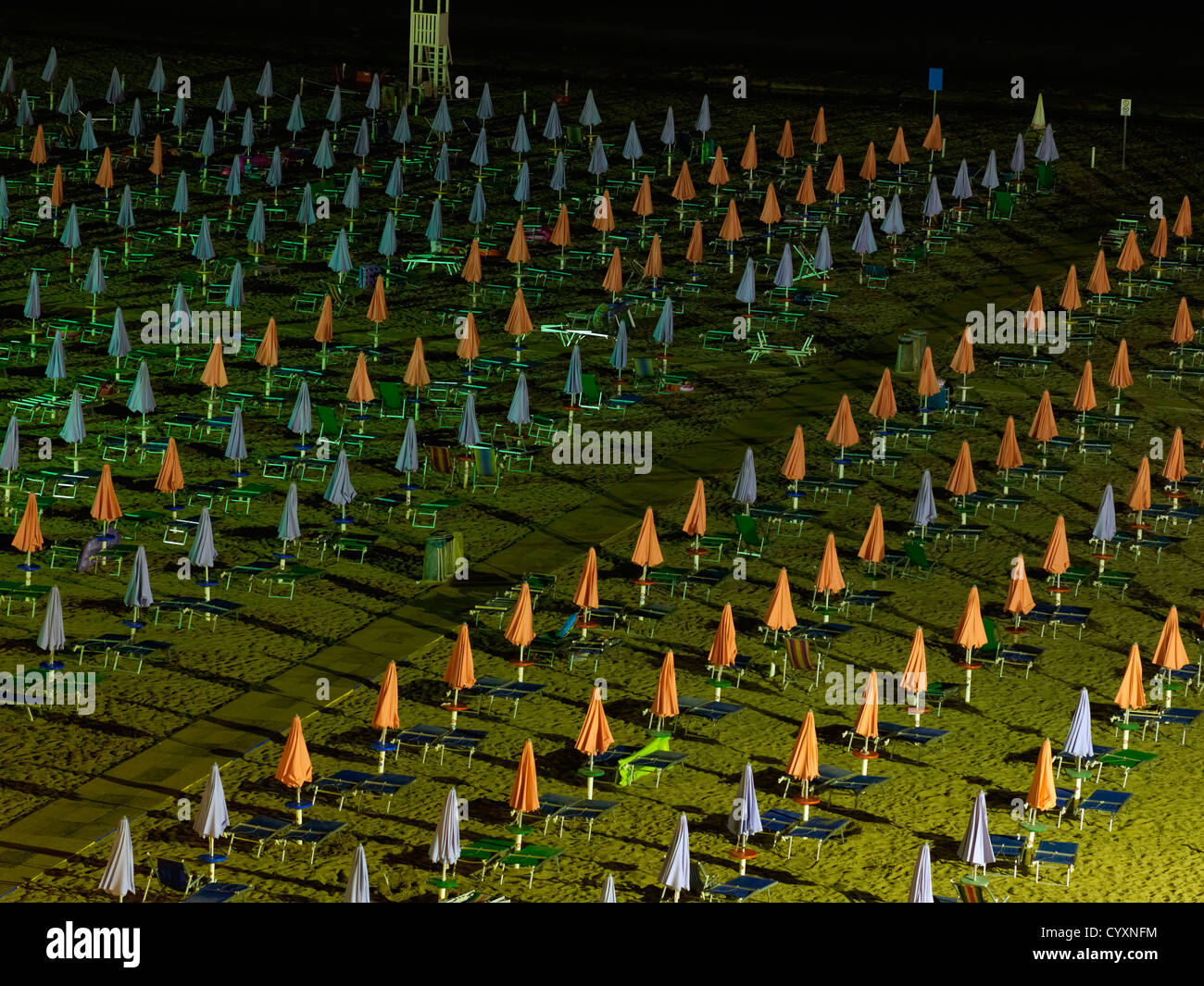 Italy, Udine, View of sun lounger and sunshades at beach Stock Photo