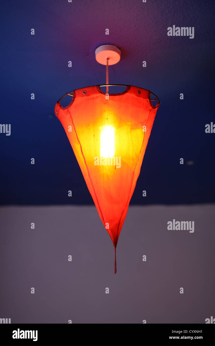 Orange Red Light Shade Light Lantern Suspended From Blue Ceiling