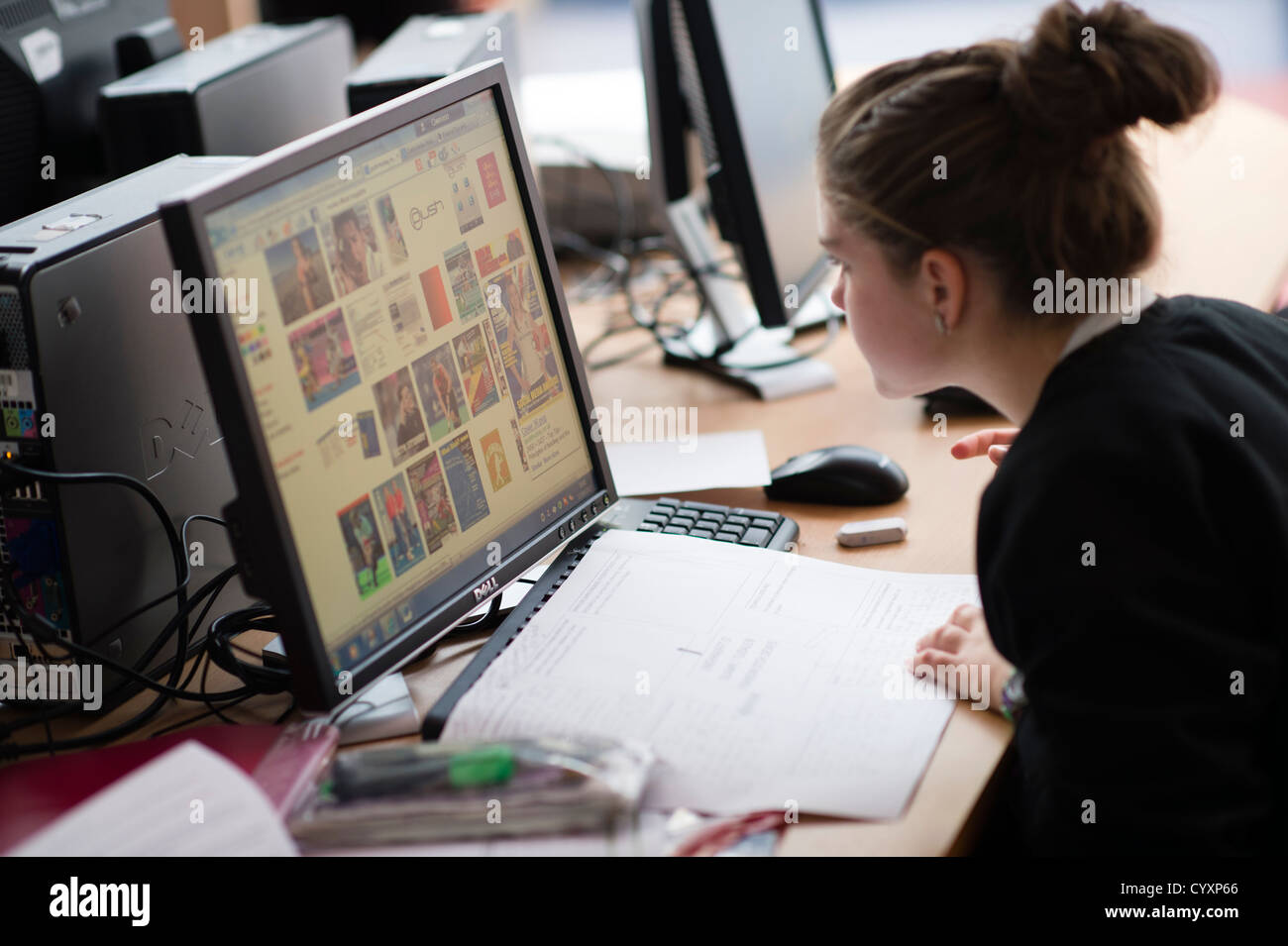 A girl  using information technology computers computing at a secondary comprehensive school, Wales UK Stock Photo