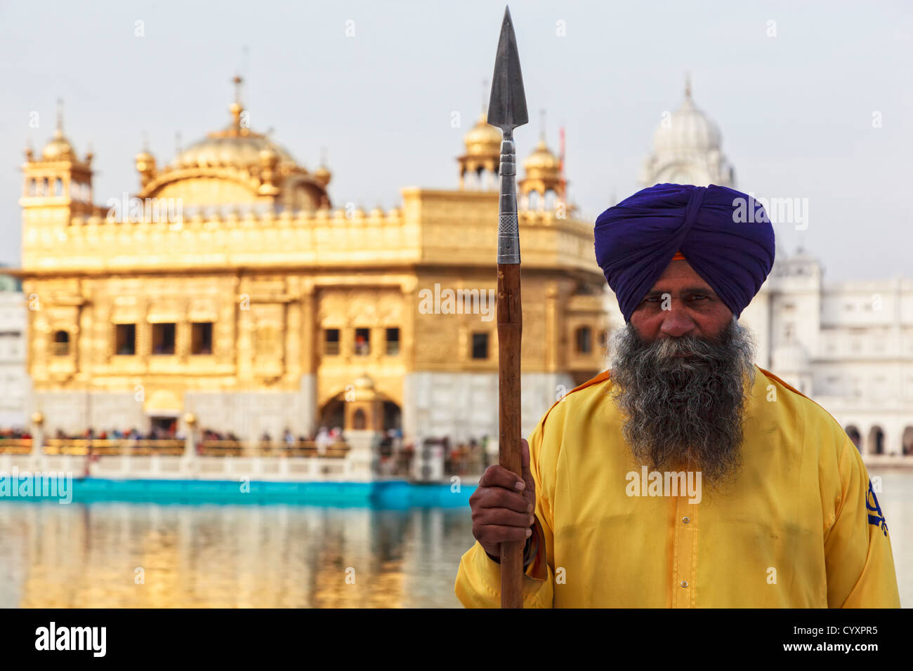 India, Punjab, Amritsar, Portrait of Sikh guard holding spear at Golden
