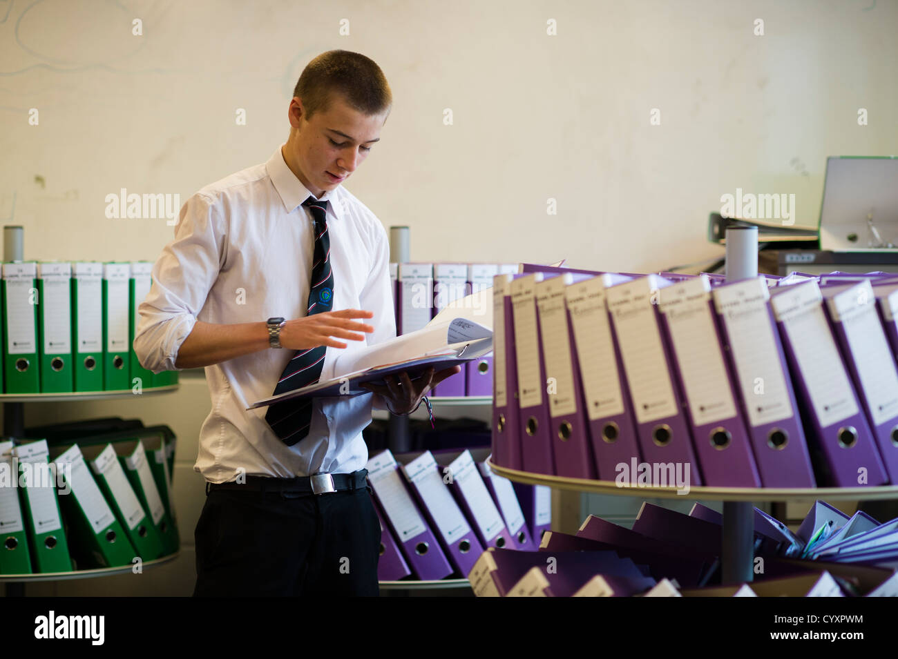 A year 13 6th form boy reading past A Level exam papers at a secondary comprehensive school, Wales UK Stock Photo