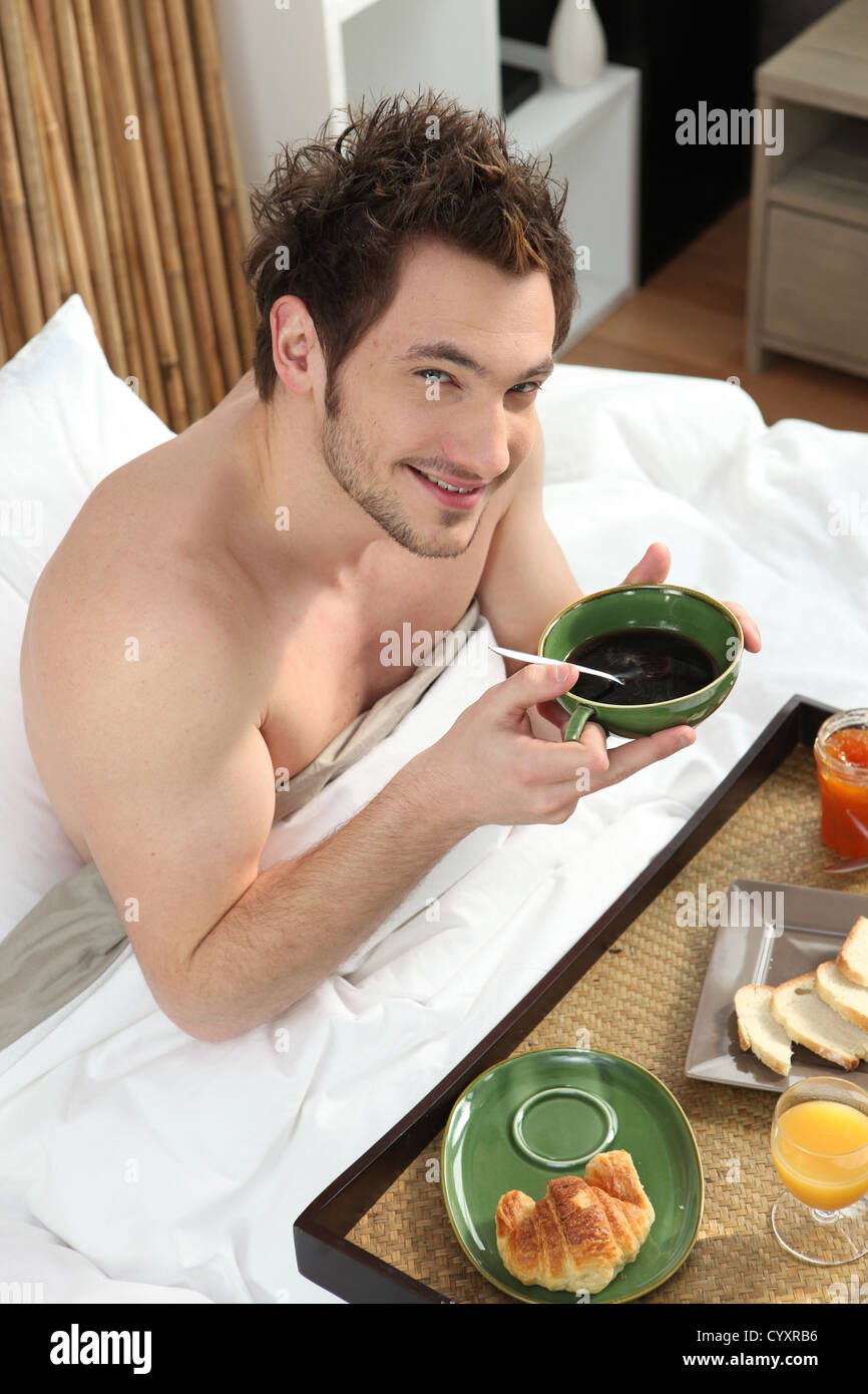 Man having breakfast in bed Stock Photo - Alamy