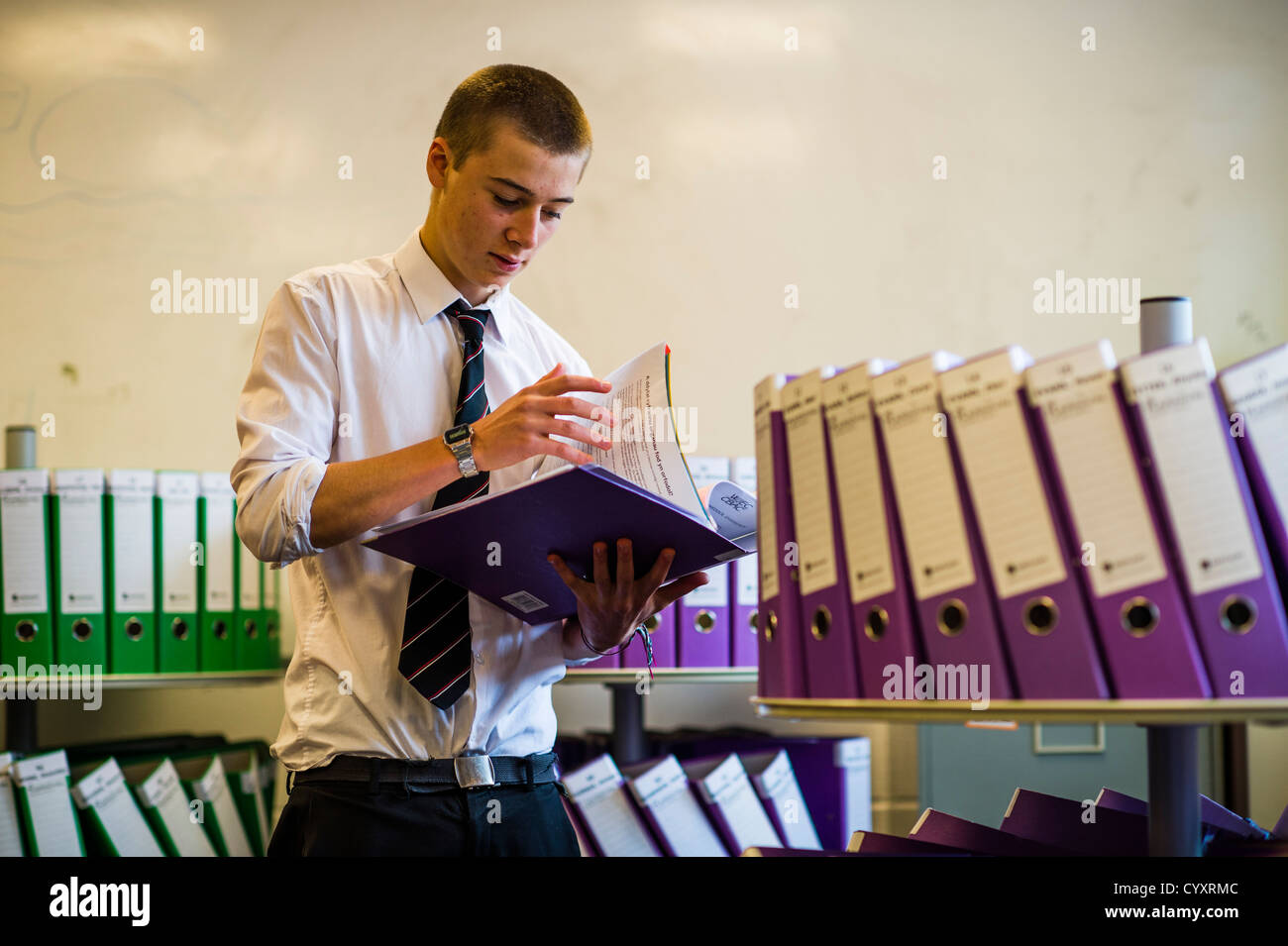 A year 13 6th form boy reading past exam papers at a secondary comprehensive school, Wales UK Stock Photo
