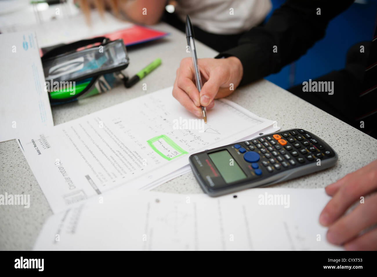 6th form year 13 girls in an science class lesson at a secondary comprehensive school, Wales UK using calculator Stock Photo