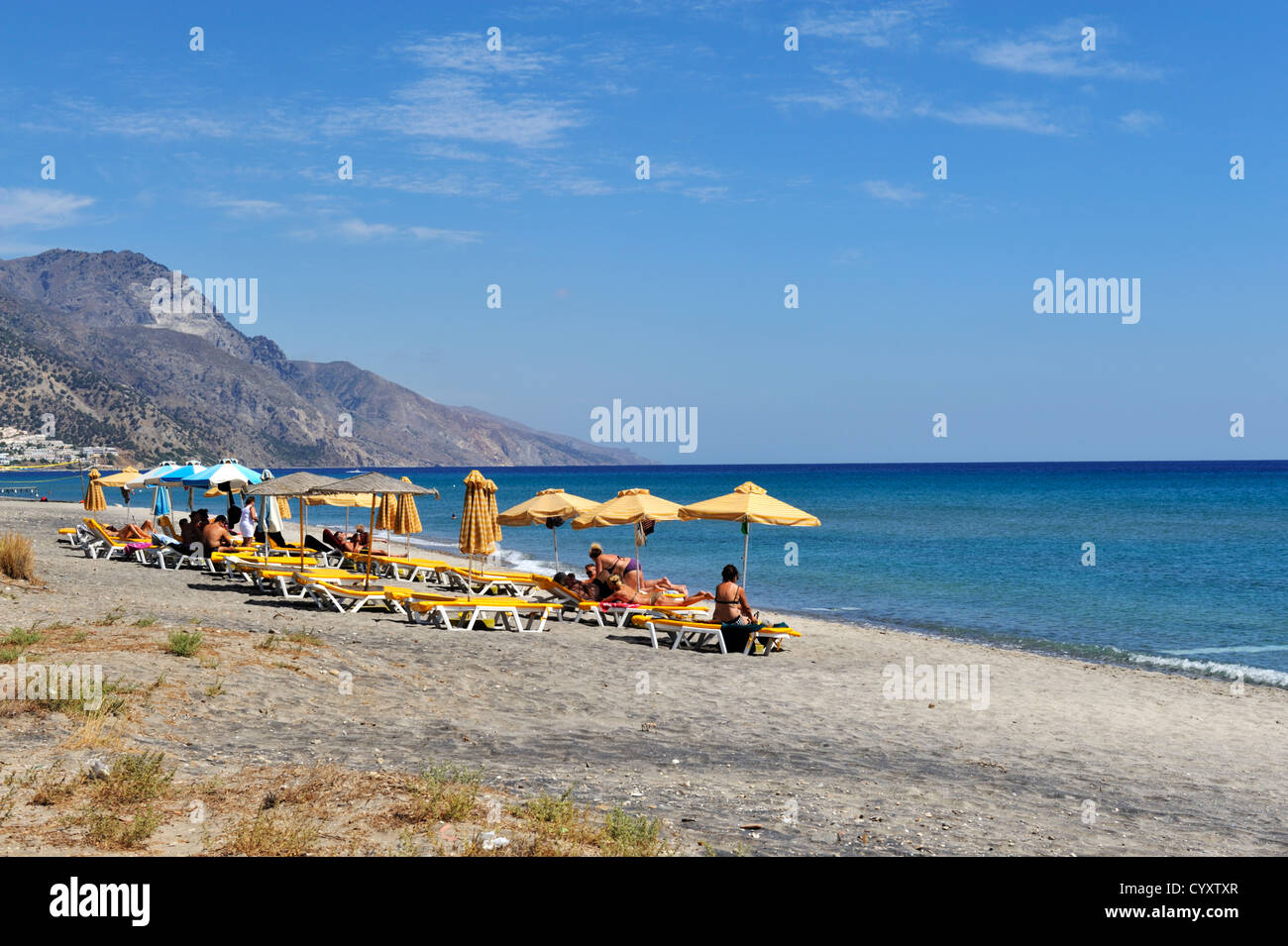 Beach with sunbathers at Kardamena, island of Kos, Greece Stock Photo