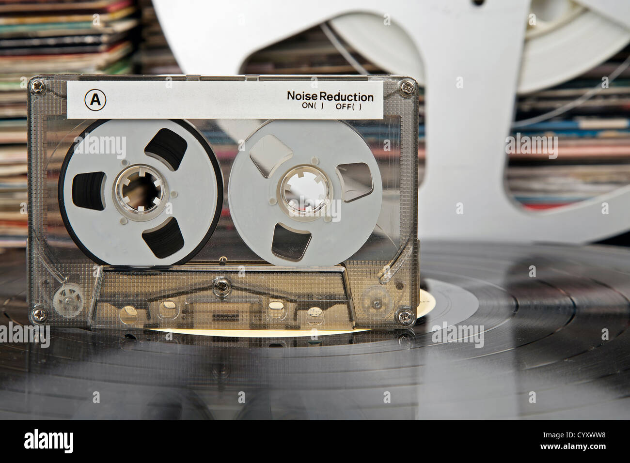 Compactcassette being on a vinyl record and audio analog tape and vinyl record covers in the