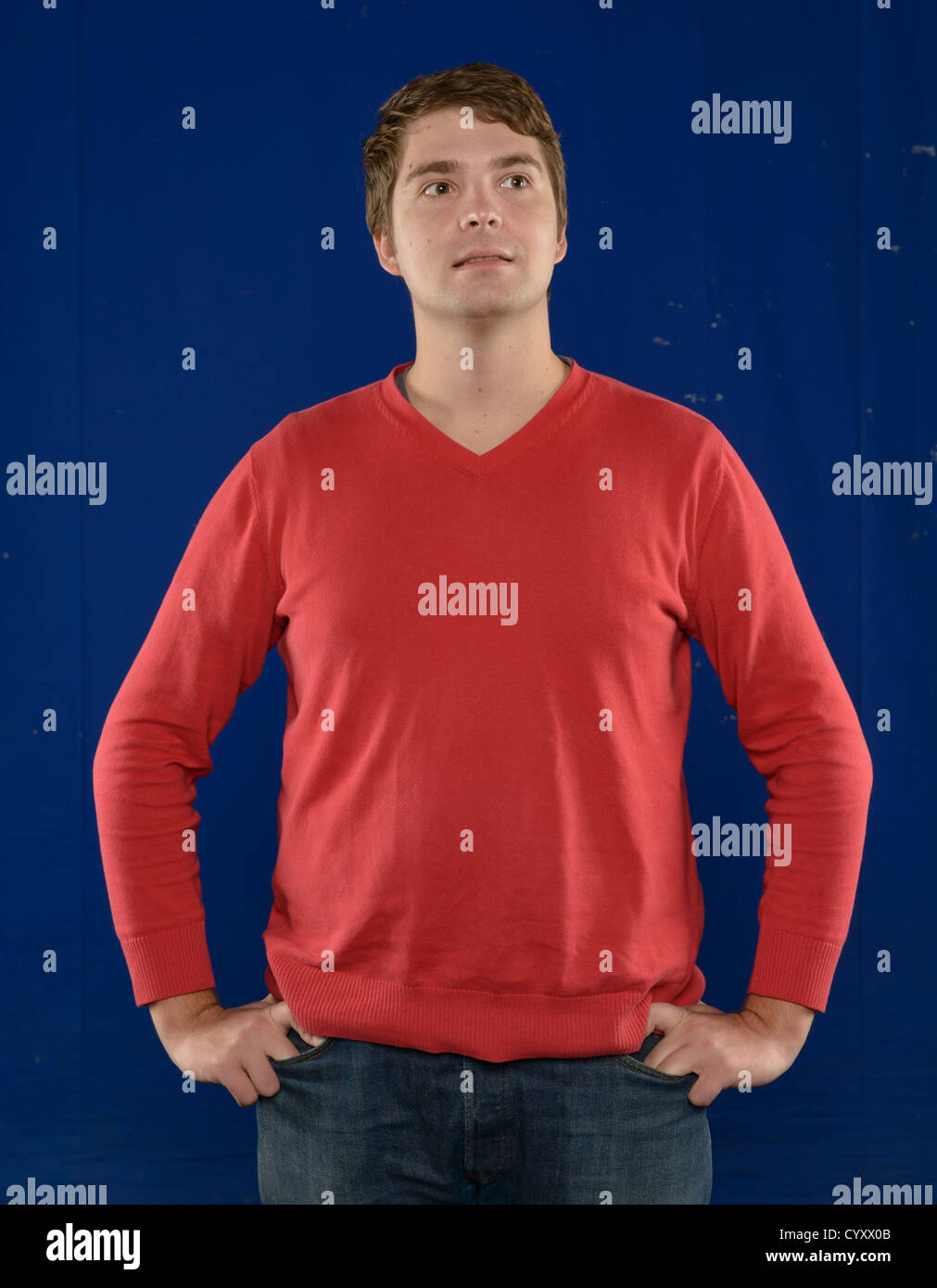 Handsome young man wearing red sweater over blue background Stock Photo ...
