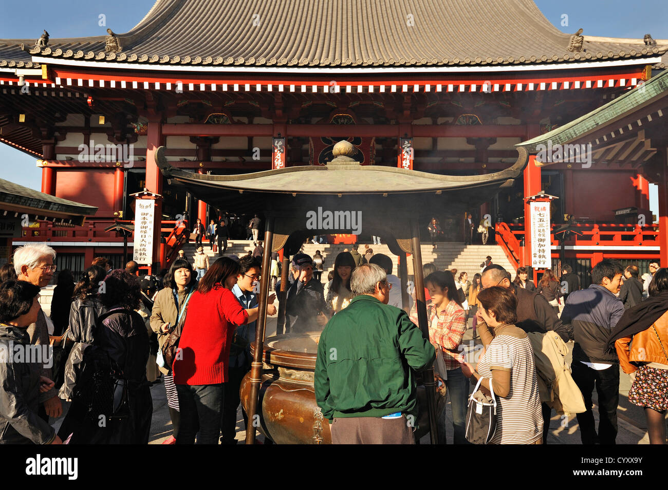 Crowds of people around the incense burner at the main hall of Senso-ji temple at Asakusa, Tokyo, Japan Stock Photo