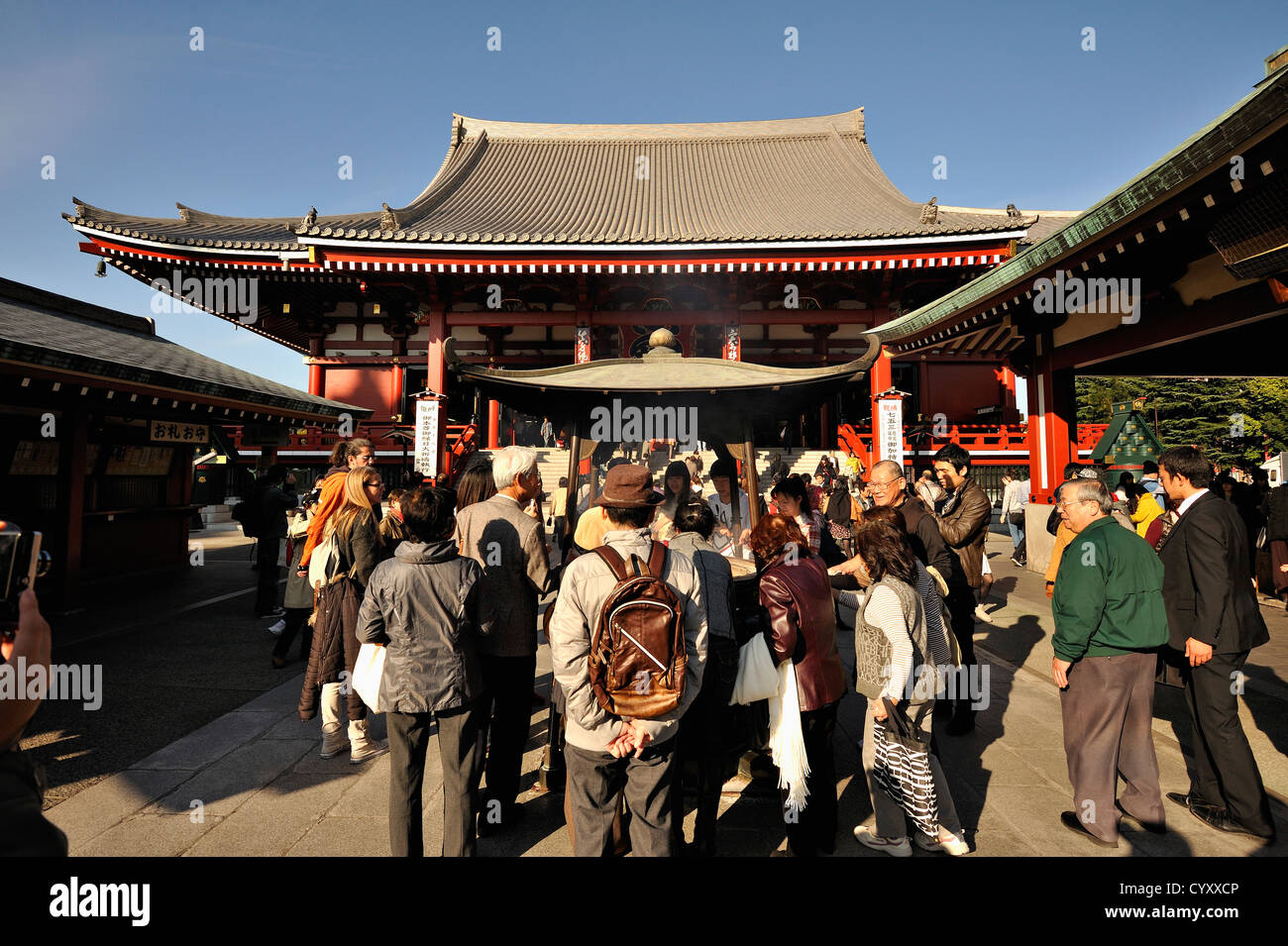 Crowds of people around the incense burner at the main hall of Senso-ji temple at Asakusa, Tokyo, Japan Stock Photo