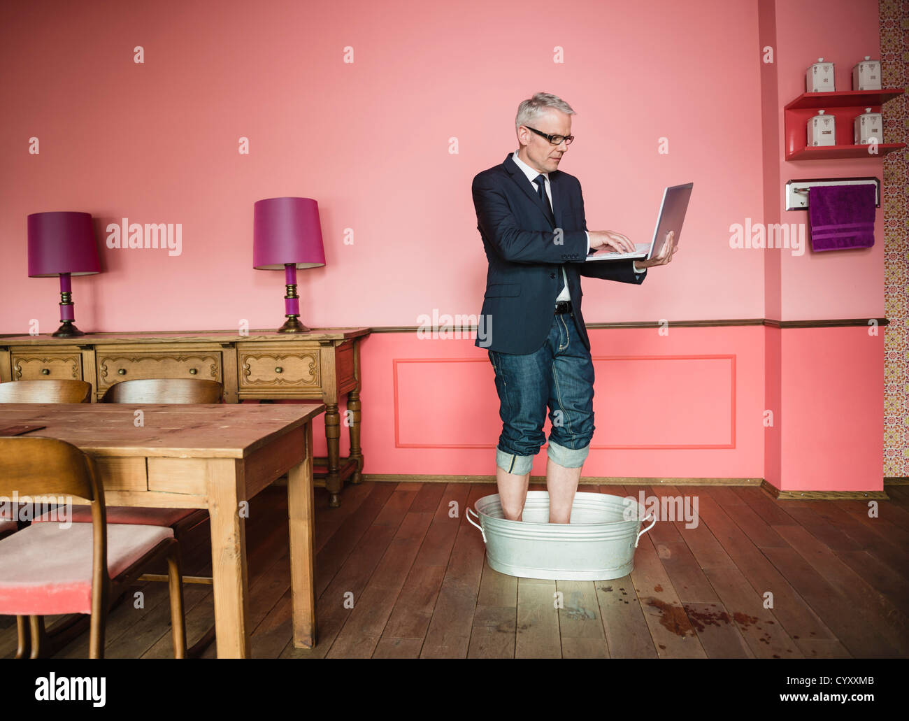 Germany Stuttgart Businessman Standing In Bathtub And Using