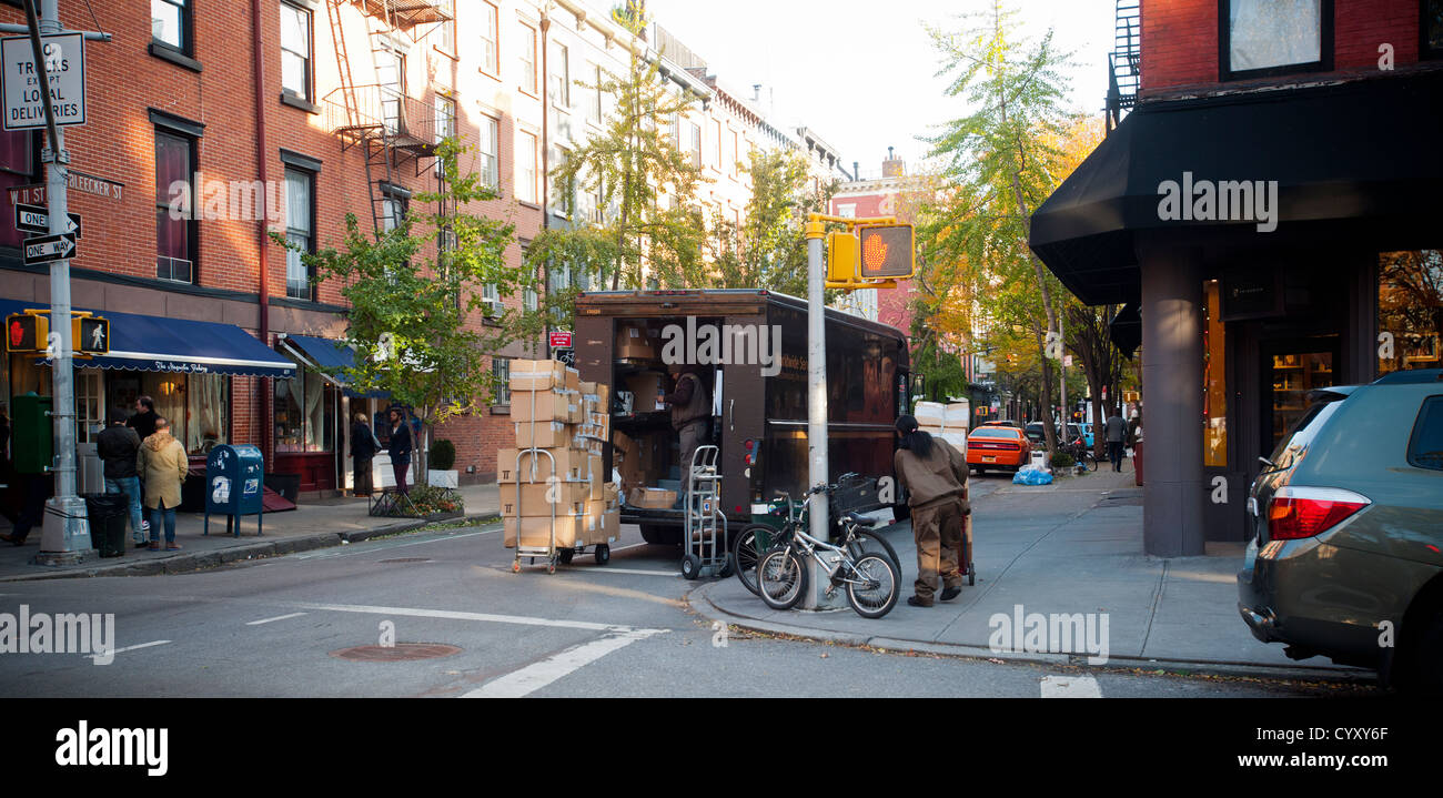 United Parcel Service couriers prepare a delivery on Bleecker Street in the West Village neighborhood of New York Stock Photo