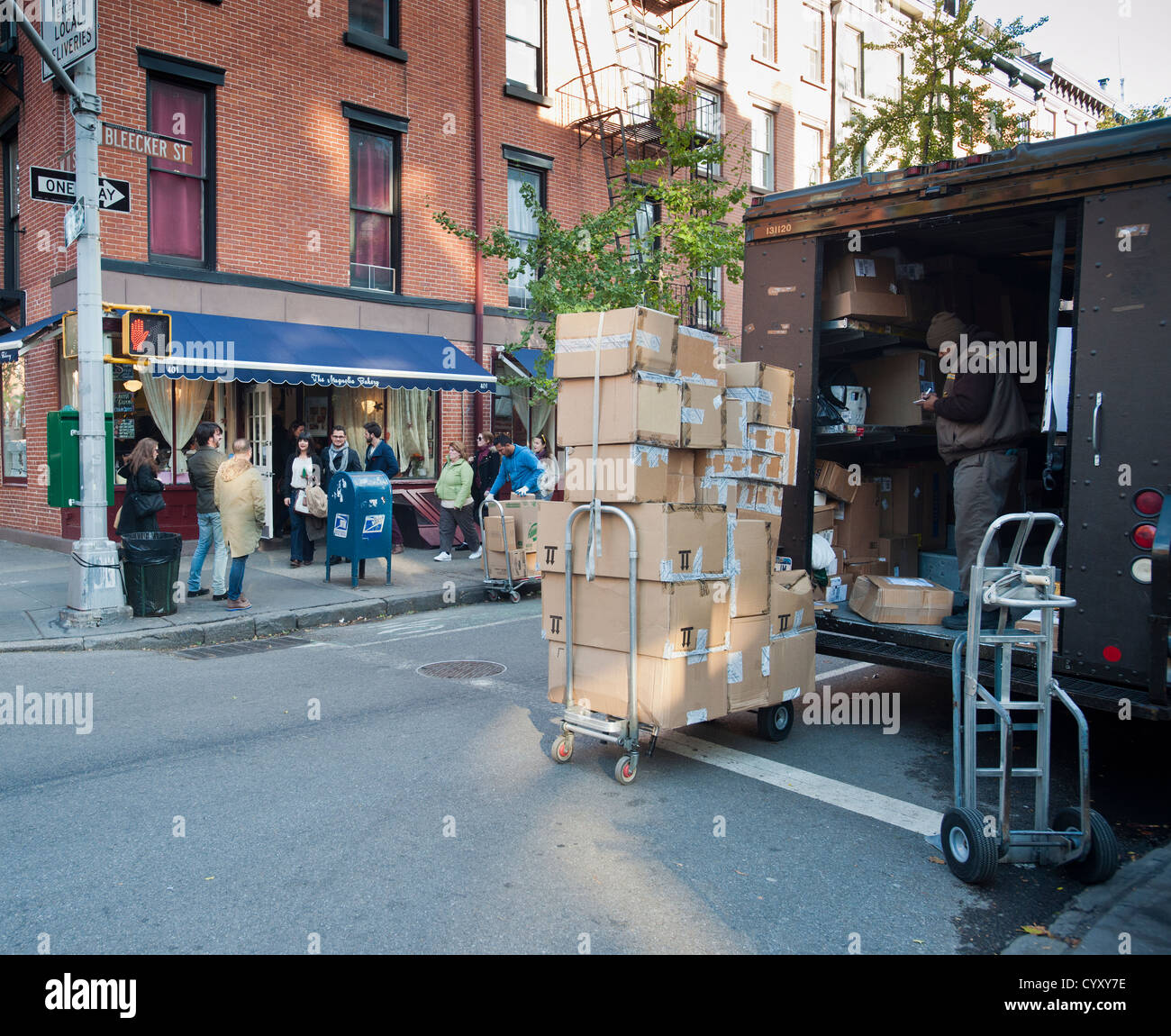 United Parcel Service couriers prepare a delivery on Bleecker Street in the West Village neighborhood of New York Stock Photo