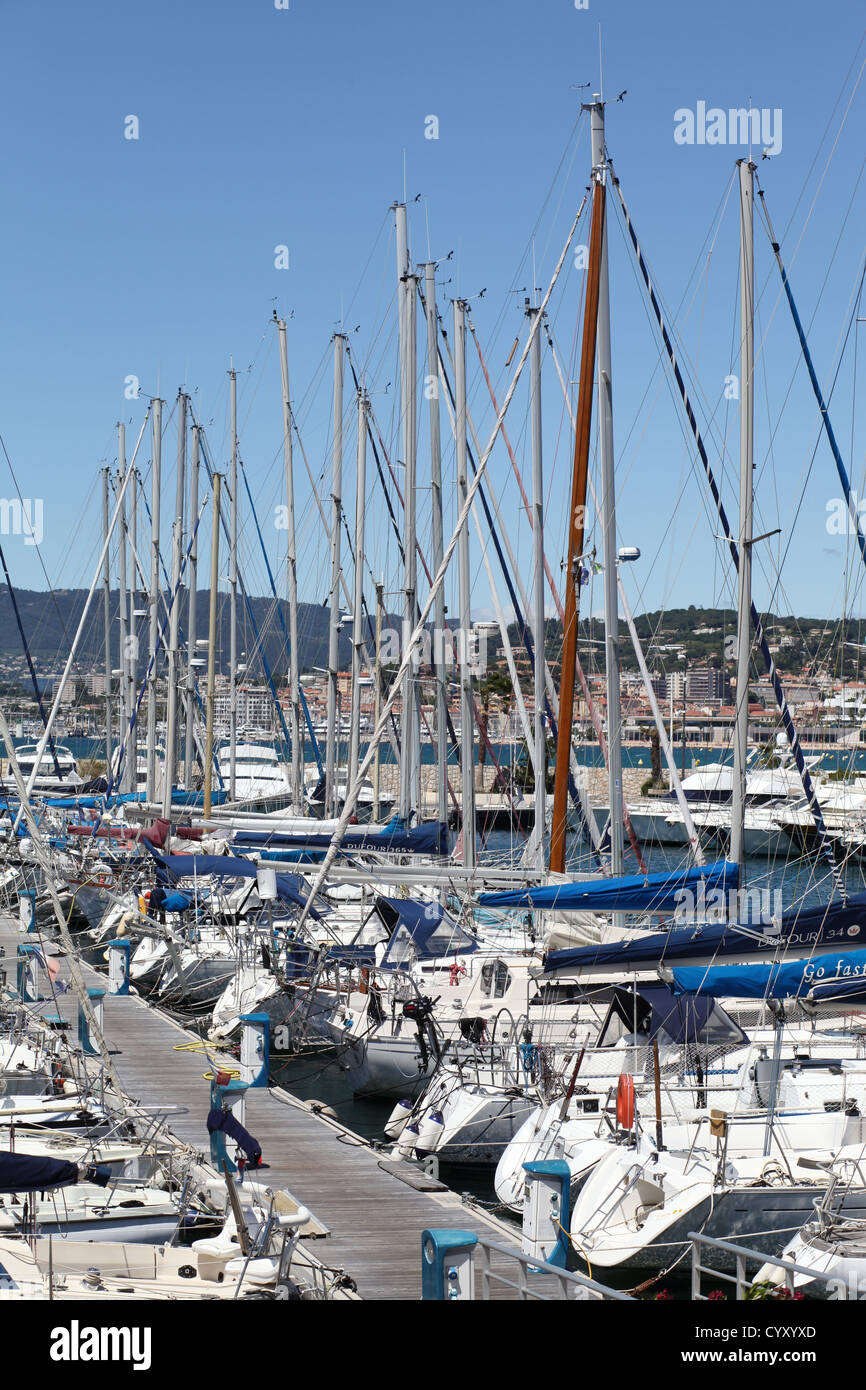 Cannes Harbour showing lots of boats blue sky and mountains in background Stock Photo