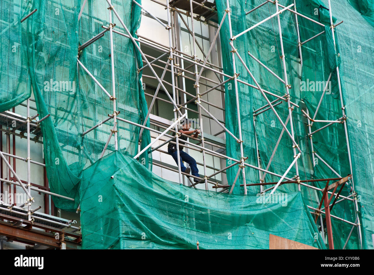 Construction Workers on a Scaffolding in Bangkok, Thailand Stock Photo