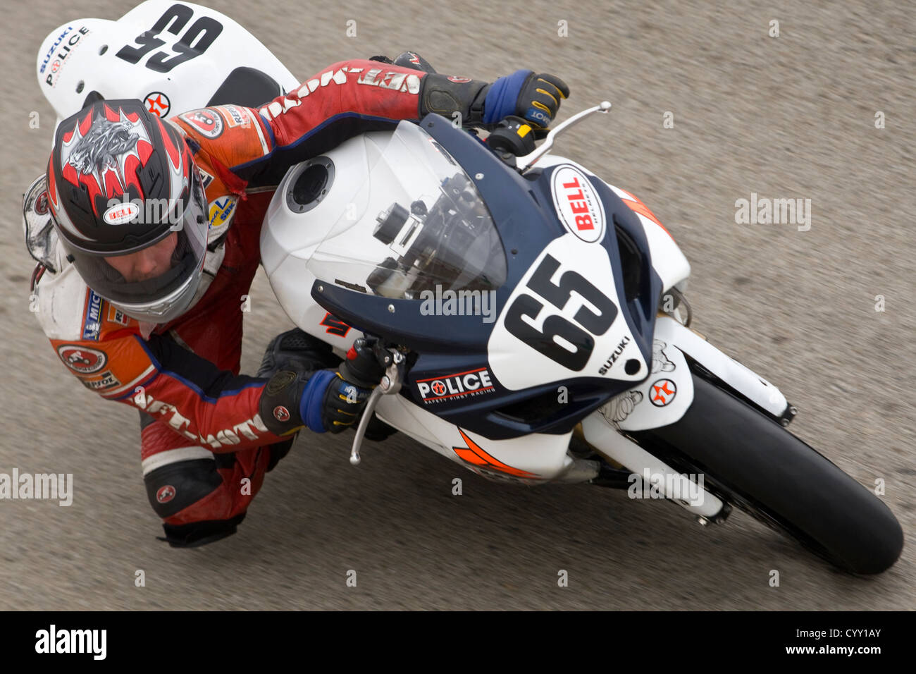 A motorcyclist races on a track at WIllow Springs International Raceway in California Stock