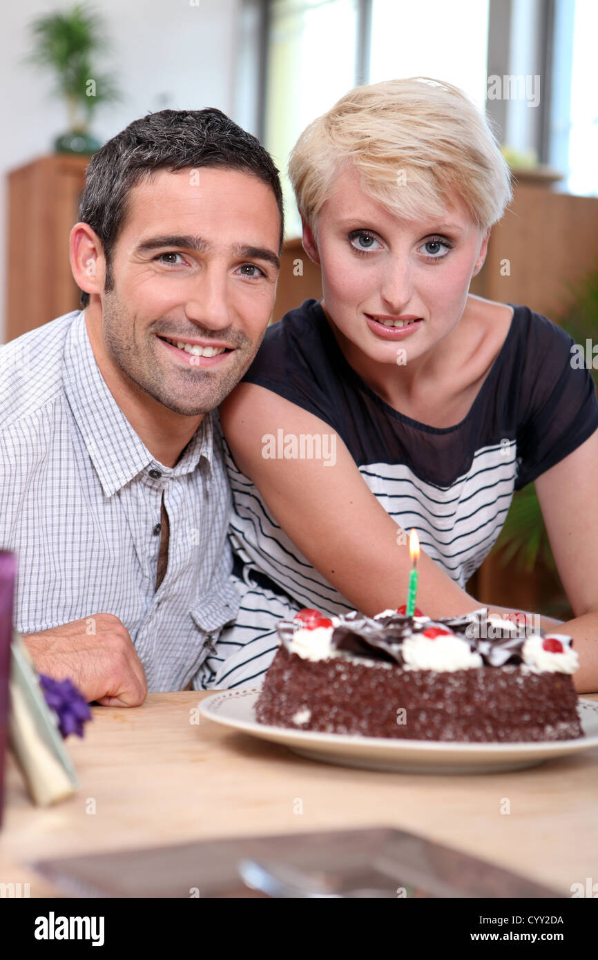Couple with birthday cake Stock Photo - Alamy