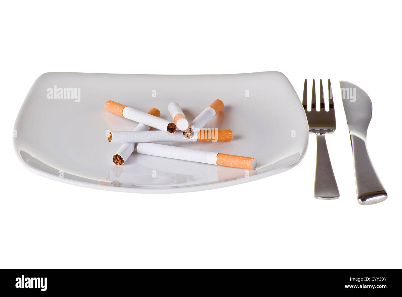 Several cigarettes on the plate with fork and knife Stock Photo