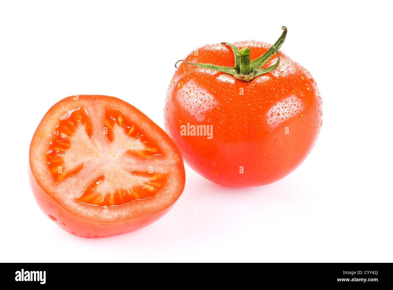 Fresh tomato with one half over white background Stock Photo