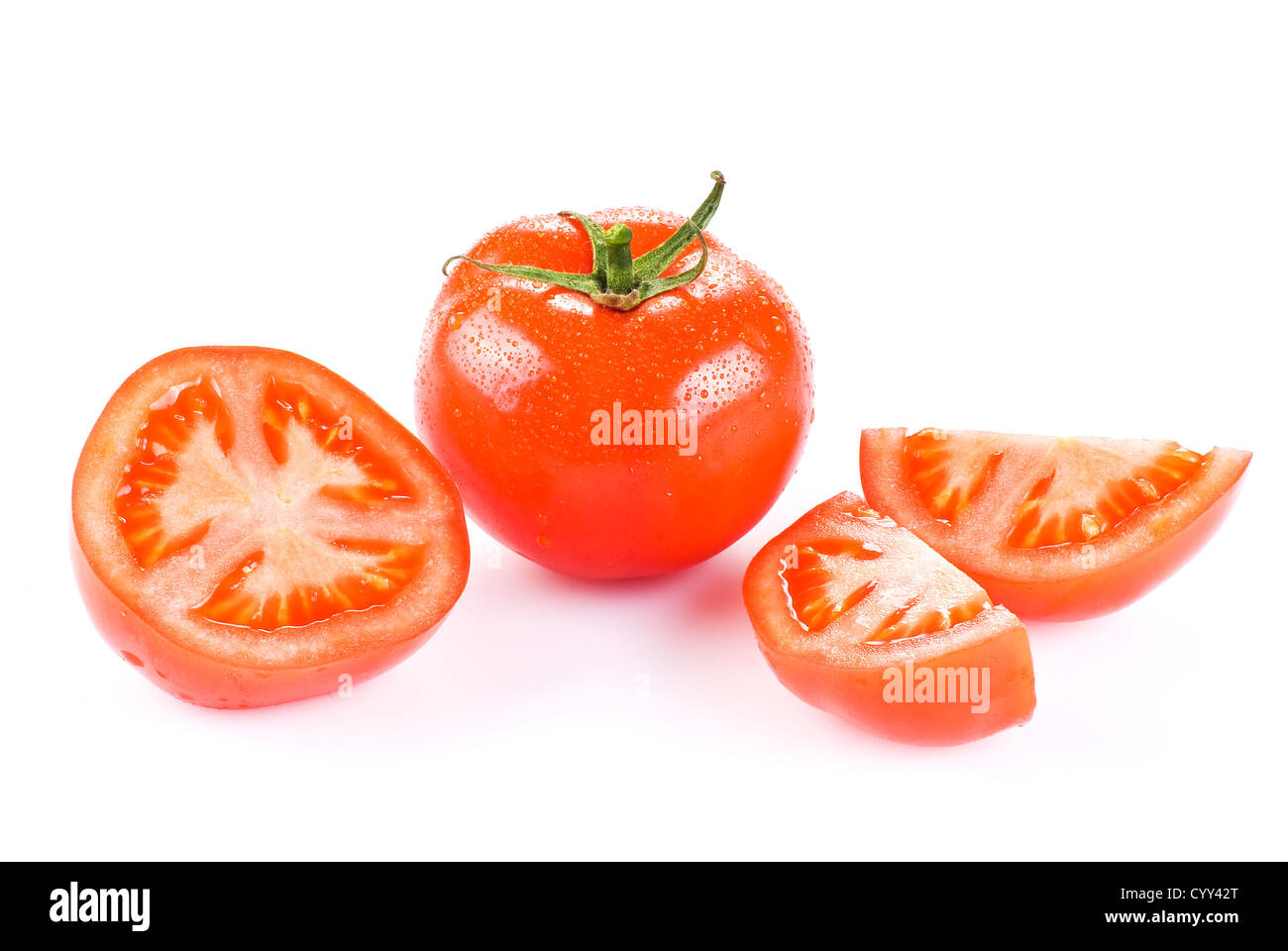 Fresh tomato with one half and two quarters over white Stock Photo