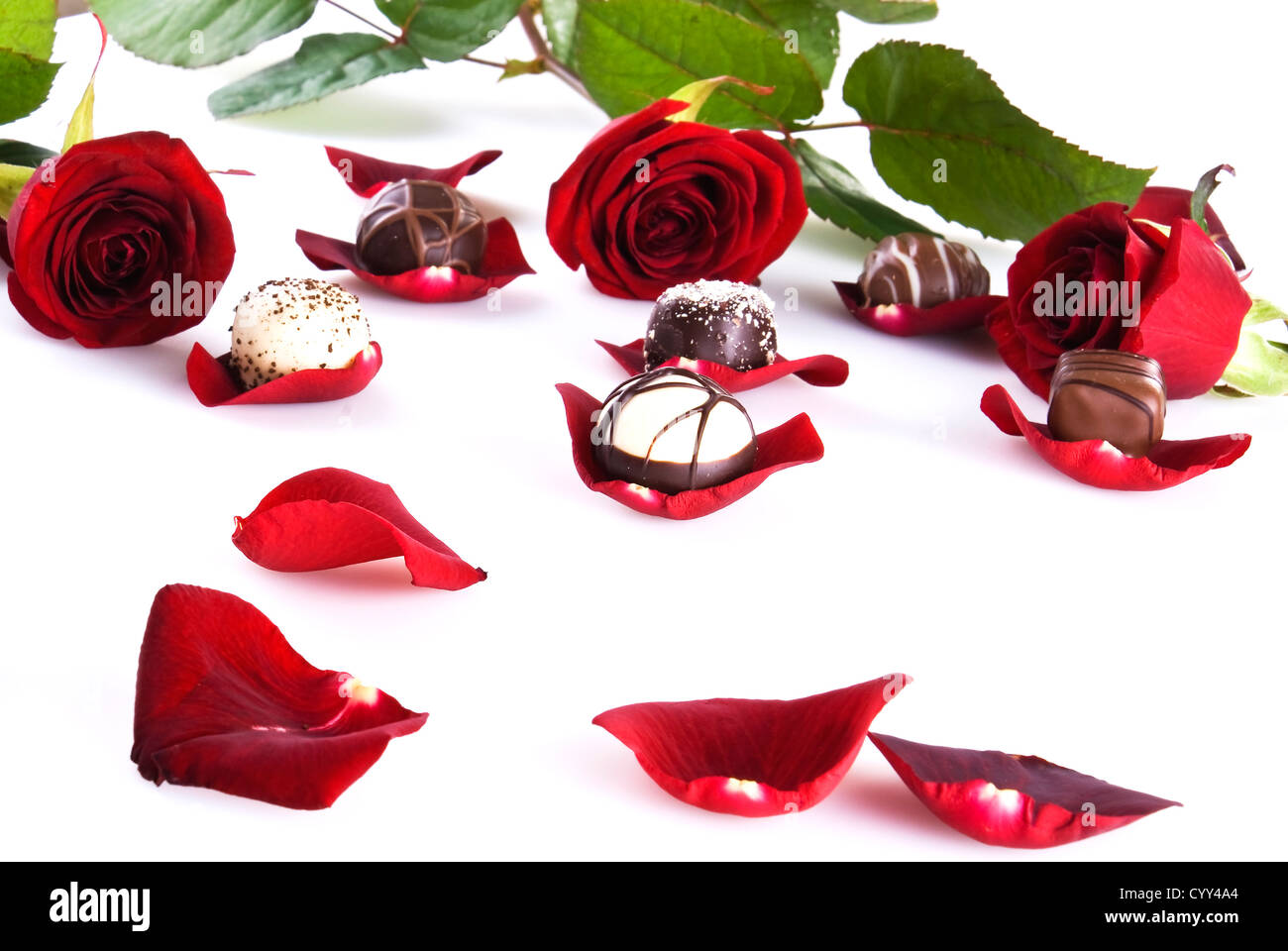 Red roses, petals, lollipops and chocolates creative composition layout.  Photograph by Milleflore Images - Pixels