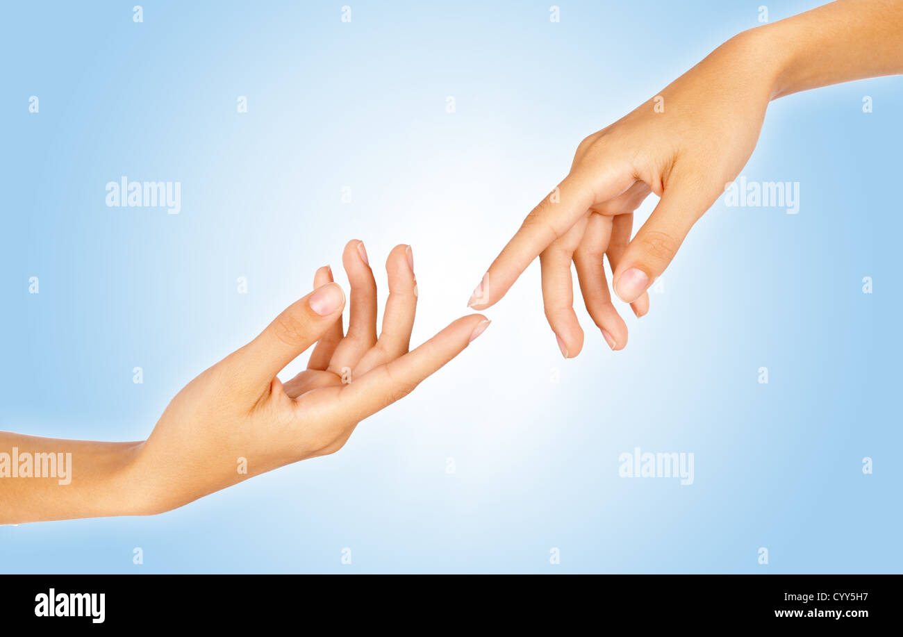Close-up of two finger tips reaching out each other over gradient blue background Stock Photo