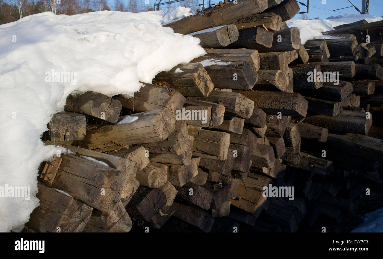 Pile of old wooden decommissioned railroad sleepers containing creosotes waiting for transport to toxic waste disposal, Finland Stock Photo