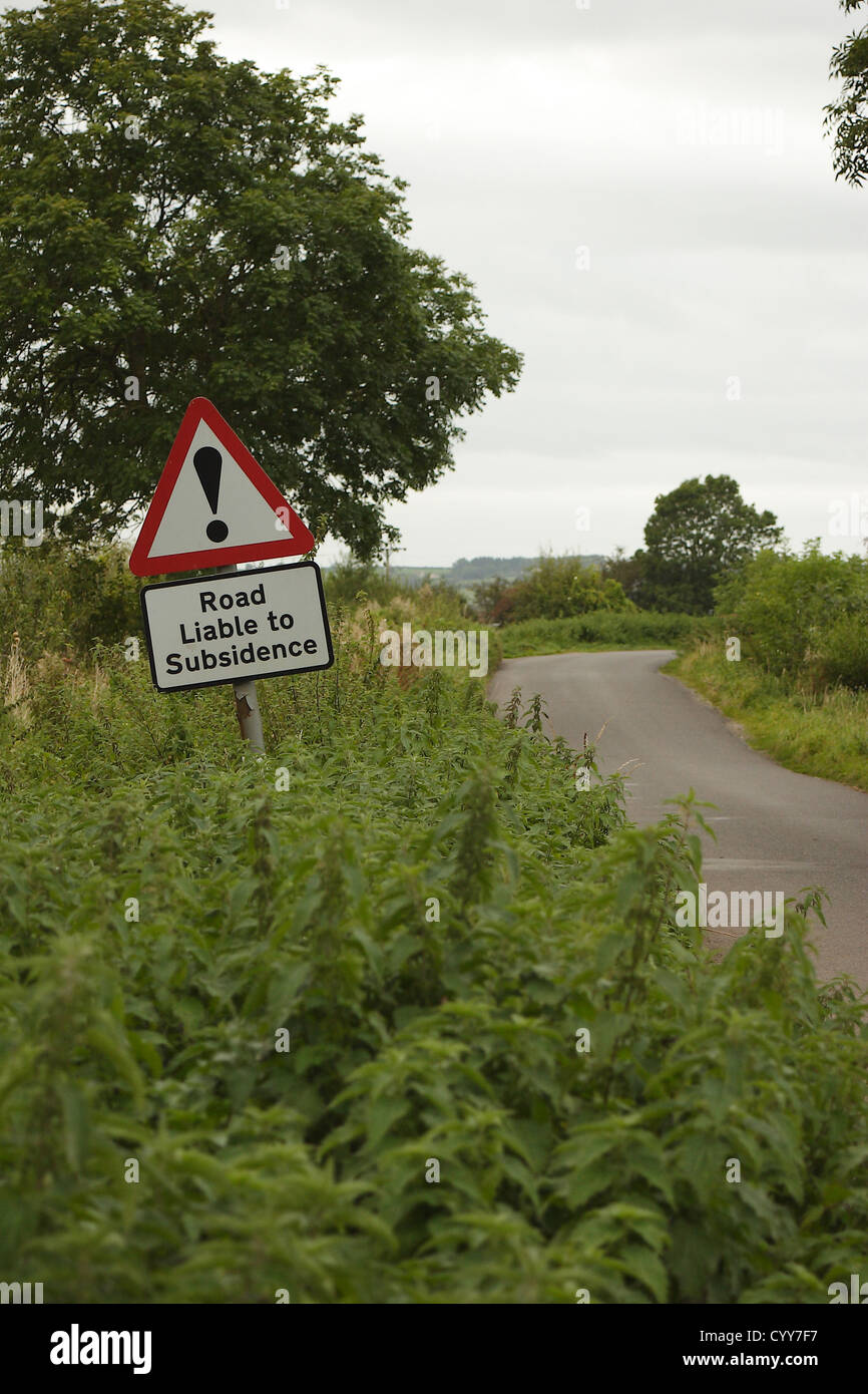 Road liable to subsidence sign on a narrow country lane, Draycott, Somerset, England, UK, September 2012 Stock Photo