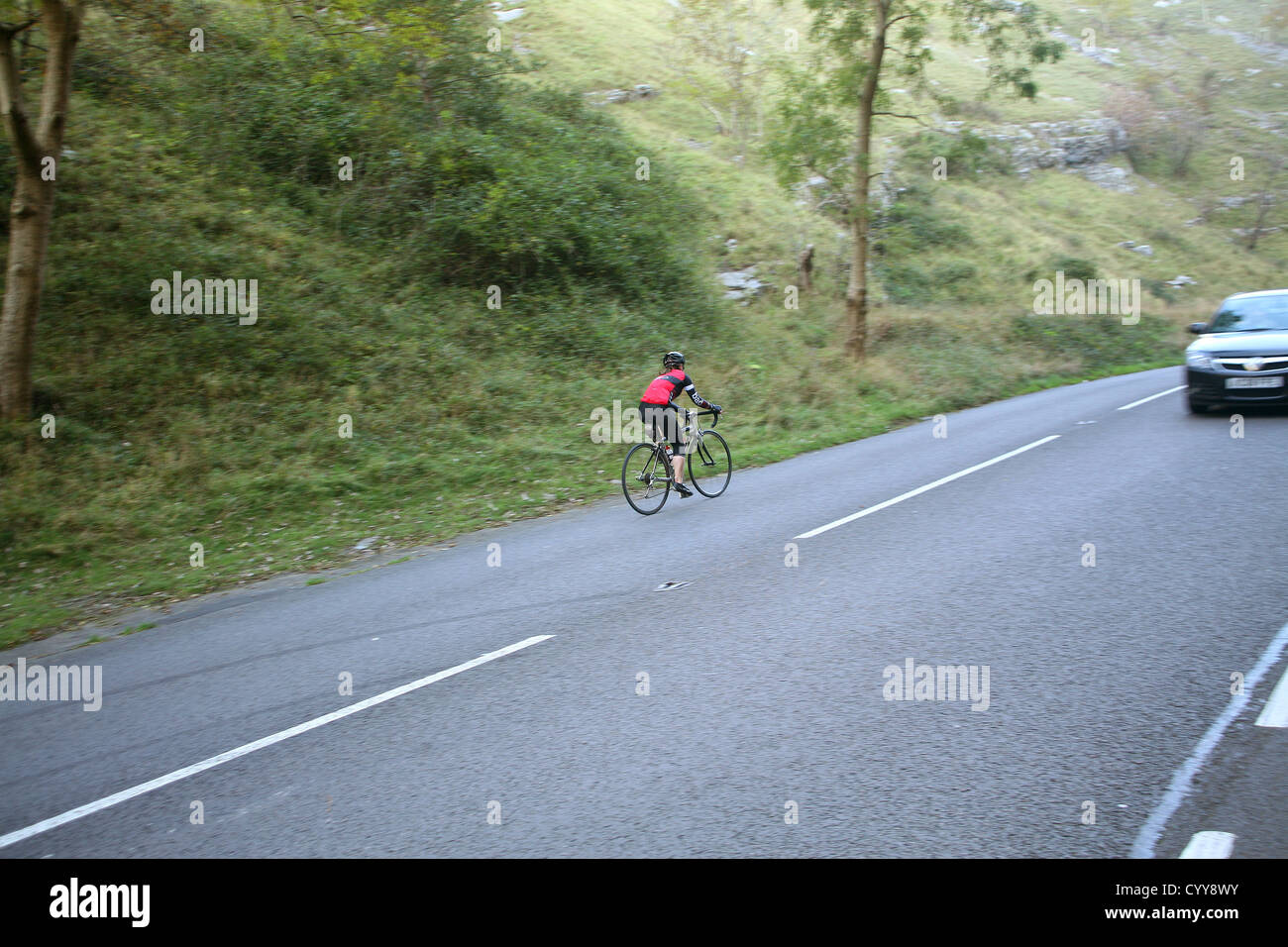 Lone female cyclist climbing Cheddar Stock Photo Alamy
