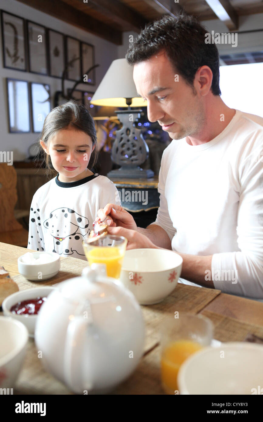 father and daughter having breakfast together Stock Photo