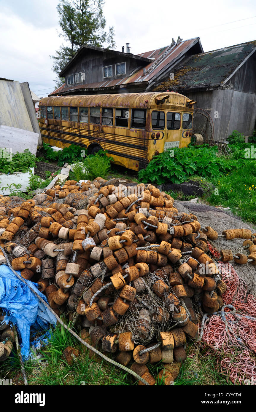 Fishing net and school bus in the backyard of a house in the Tlingit