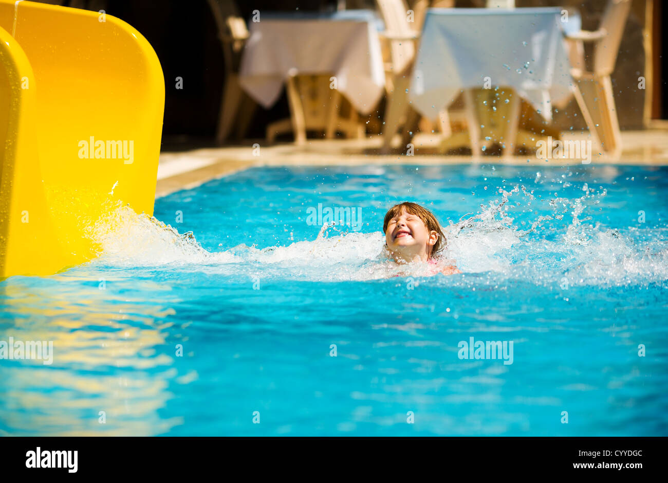 Girl Sliding in pool during Turkey vacations summer holiday Stock Photo