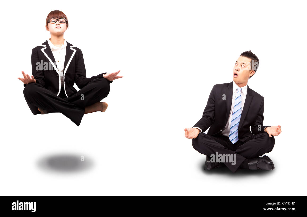 businesswoman and businessman in yoga lotus-pose and relaxing. Surprised man watching woman Floating in the air Stock Photo