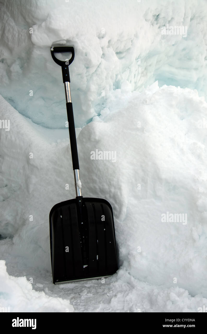 A black snow shovel in the snow Stock Photo Alamy